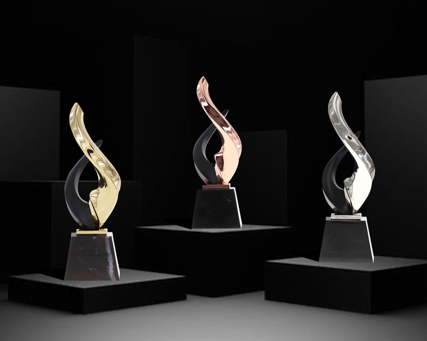 Three Nambe Lark Awards in Bronze, Silver, and Gold on Pedestals