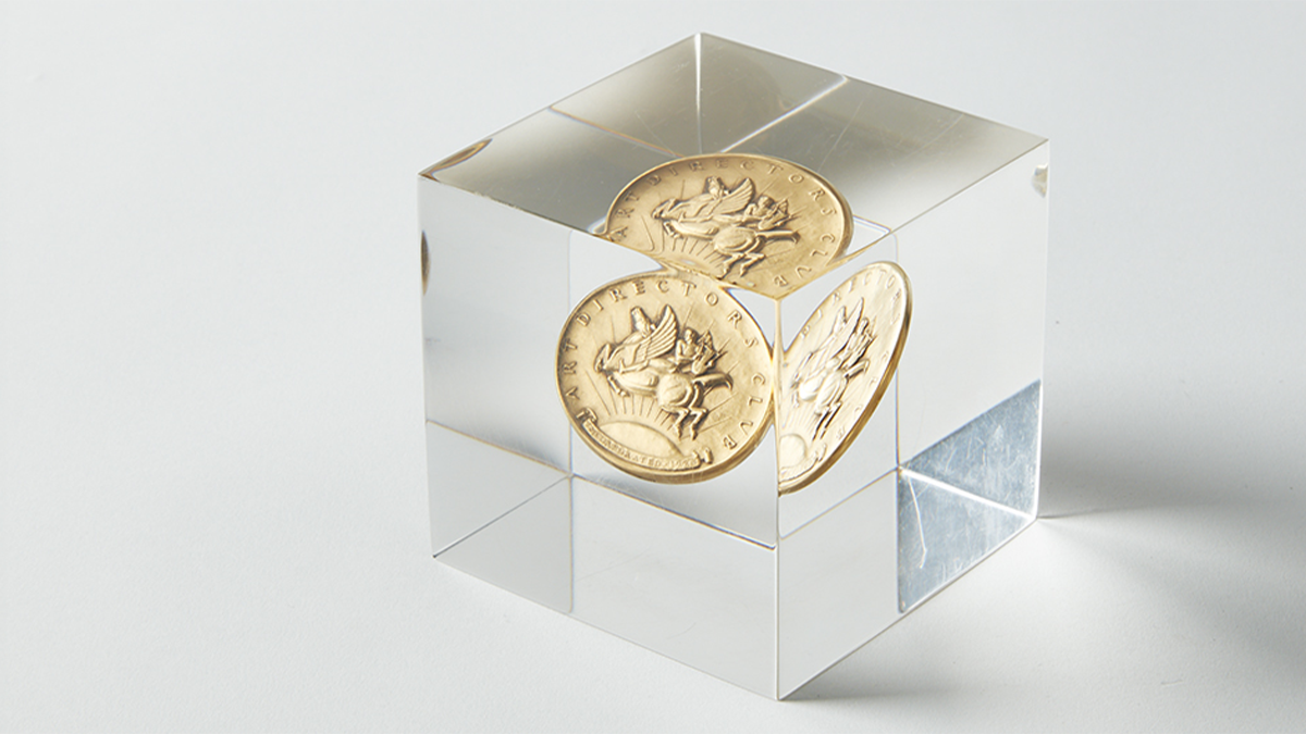 2026 Art Director's Club Awards Paul Manship Trophy with original design Paul Manship medal incased in an acrylic cube