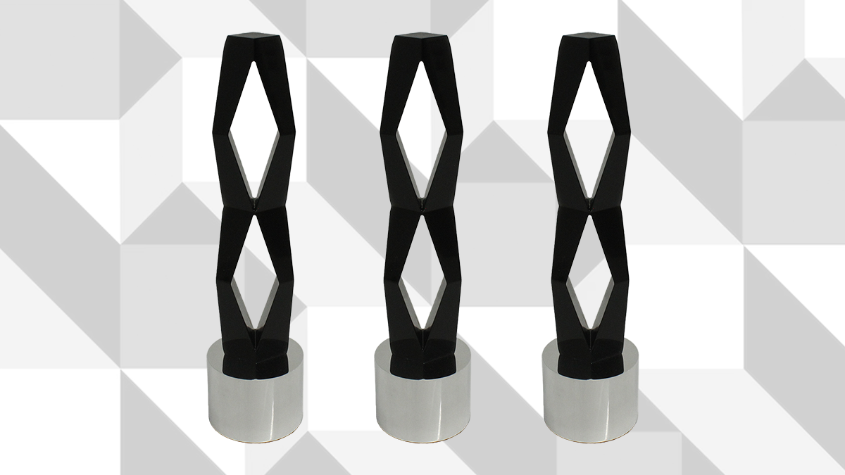 3 International Center of Photography ICP Infinity Award Trophies side by side on a white geometric background