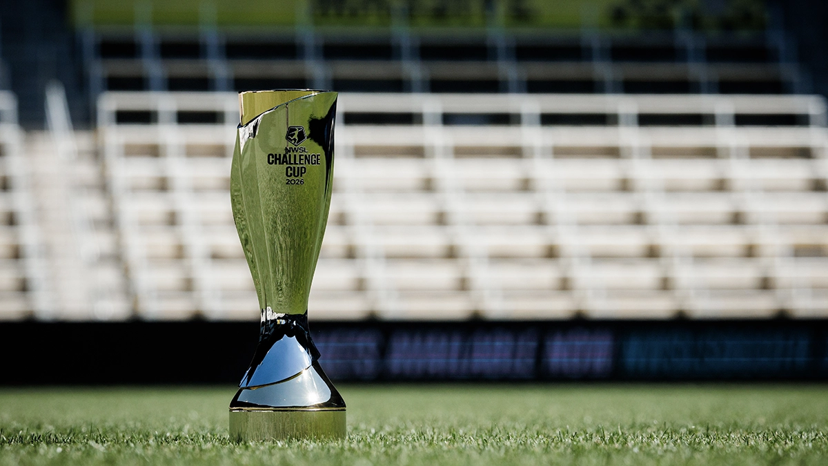 The National Women's Soccer League Challenge Cup trophy on a soccer pitch with a soccer ball