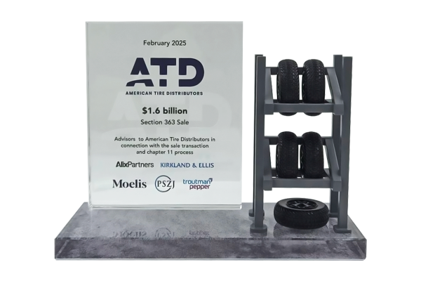 Detailed deal gift with 3D tire rack on right and text on crystal rectangle on grey base