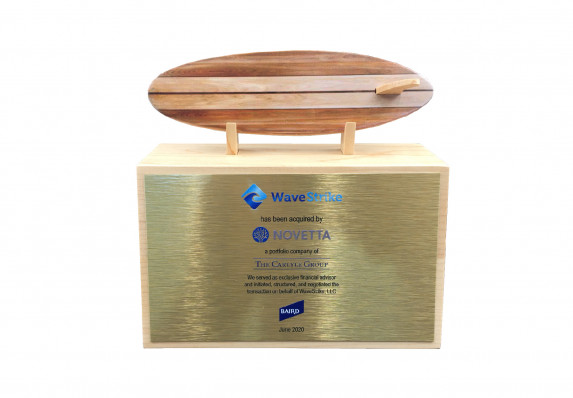 A wood surfboard model is is presented atop this unique custom deal toy with elegant gold tombstone plaque.