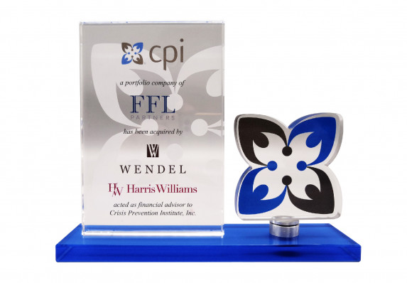 This modern financial tombstone was crafted with a large plaque to display transaction details alongside a custom-cut logo plaque and a branded-color base.