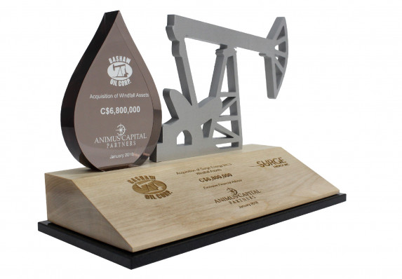 Deal toy created for an acquisition. Design incorporates a Lucite oil drop with colorfill as well as a machined outline of an oil drill.