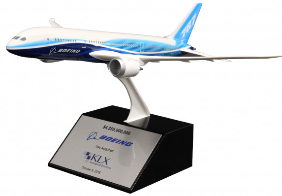 Model plane with custom branding is mounted on a tapered base.