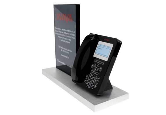 Highly detailed model of a business phone and a financial tombstone plaque mounted on a base for a bankruptcy deal.