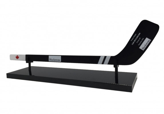 A luxury custom deal toy with financial transaction details outlined on a realistic hockey stick model crafted in acrylic.