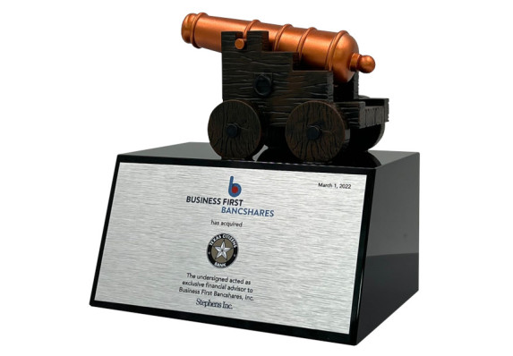 Cannon on top of black wedge base with metal plate