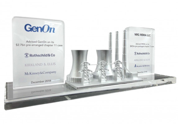 Two tombstone plaques on a long base present the details of a Chapter 11 transaction. This luxury deal toy is accented with 3d-printed utilities details.