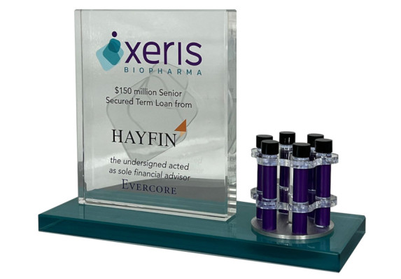 Clear crystal rectangle with chemical tubes on metal holder on color base