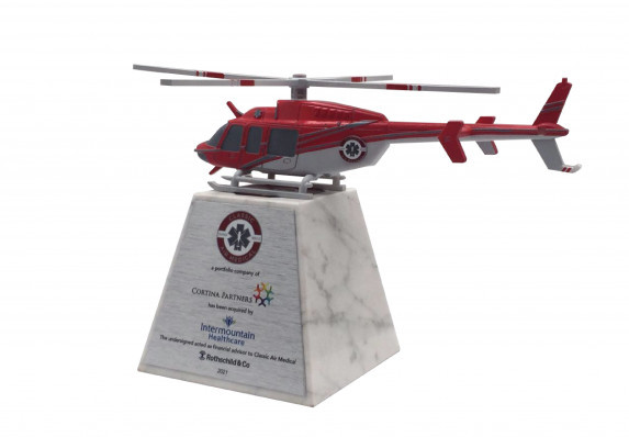 This custom deal gift includes a 3D printed helicopter sculpture on a marble base with the tombstone details.
