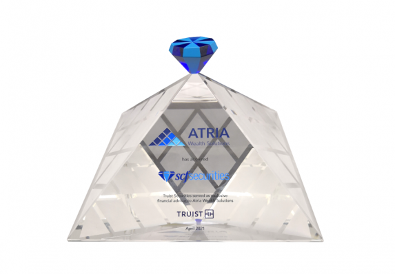 A crystal financial tombstone for the acquisition of a wealth management firm. The design has a modern pyramid design.