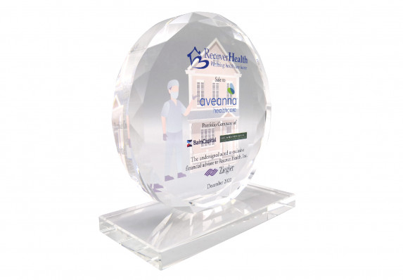 A high-end crystal deal gift with faceted edges, reverse printed images and color printed transaction details. This custom financial tombstone was presented to commemorate the close of a company sale.