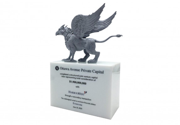 A custom deal toy with a highly-detailed silver griffin mounted on a base with the details of a structured joint venture capital deal.
