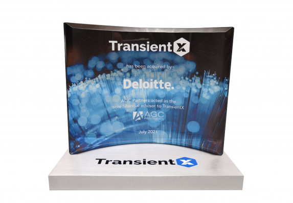 A custom, luxury financial tombstone with a crystal plaque and metal base.