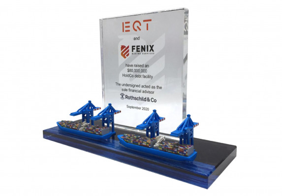 This unique custom financial tombstone includes a reverse-etched plaque with financing transaction details and model shipping freighters and cranes.