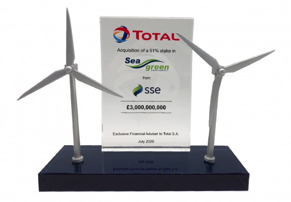 Custom deal gift with models of wind power generators alongside a crystal tombstone plaque with the details of a 51% stake deal.
