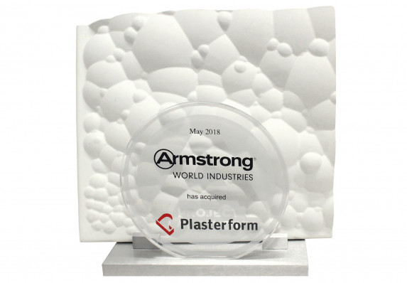 Round plaque with logos and tombstone text mounted on base with product model.