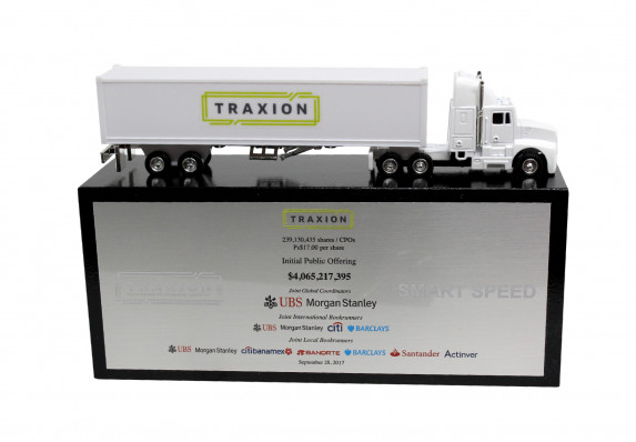 Custom deal toy with a model semi truck mounted on a base with a complex financial tombstone.