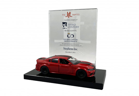 Custom deal toy with a frosted logo plaque and scale model car presented at the close of a acquisition deal.