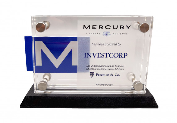 This modern deal gift, created for the close of a financial acquisition, is made up of multiple crystal plaques that are held together with stainless steel mounts on a black base.