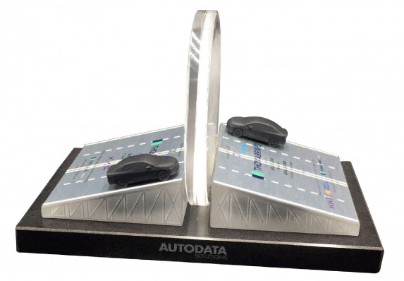 This complex deal gift combines 3D printed cars on metal plaques printed with financial transaction details. These elements are combined on a marble base with an etched logo.