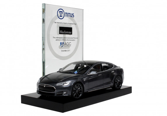 Custom deal toy with a frosted logo plaque and scale model car presented at the close of a financing deal.