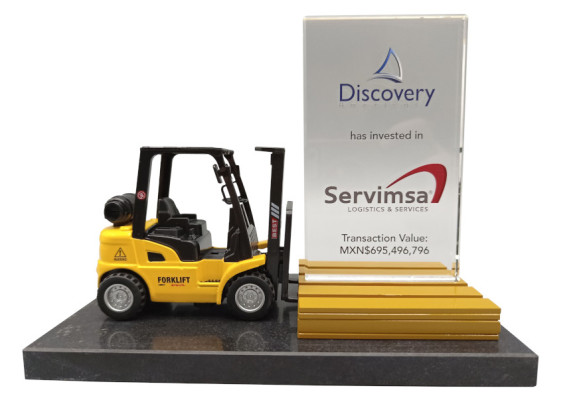 Forklift with gold bar on granite base