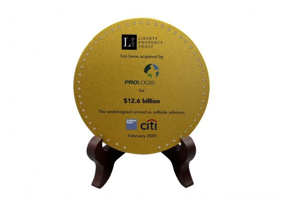 This unique gold medallion financial deal toy was crafted for the acquisition of a real estate company.