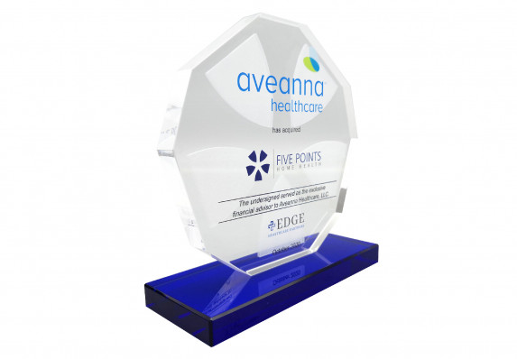 A crystal deal toy with reverse etching and color printing presented on a blue base for a healthcare brand acquisition deal.