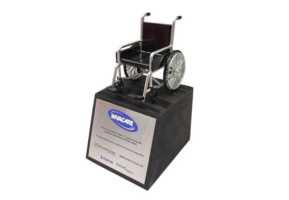 Healthcare deal gift with a black stained base and model wheelchair featured prominently