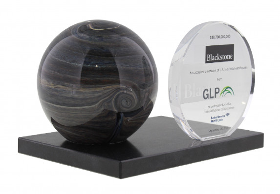 Color Logos Were Printed on a Crystal Plaque in this Unique Deal Toy. The Crystal is Mounted on a Modern Black Base with an Artful Sculpture. This Tombstone was for a Large Deal Involving the Acquisition of US Warehouses.