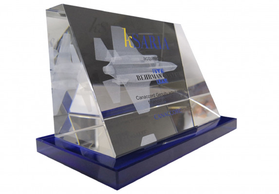 Tapered clear crystal deal toy is decorated with text and logos and a 3d etched fighter jet.