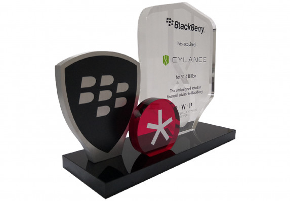 This deal gift incorporates three plaques—one with financial acquisition details text and two with brand symbols—onto a long black base.