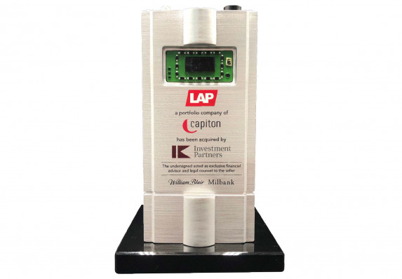 Acquisition deal toy with financial transaction details presented on a detailed product model.