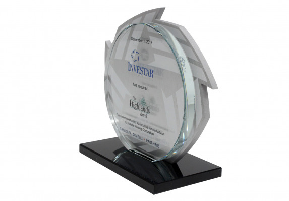 Deal gift commemorating the close of an acquisition finance deal. The form has a machined acrylic logo with etching with a second tombstone plaque on top both mounted on base.