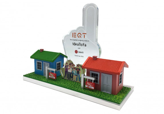 Custom 3D-printed deal toy with model houses that was crafted and presented for the close of a financial acquisition.