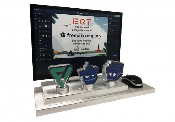 A luxury deal gift with financial transaction details on a model computer. This majority-stake acquisition tombstone was created for a tech deal.