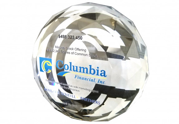 Faceted crystal deal toy with color printed deal toy text presented in honor of a minority stock offering deal.