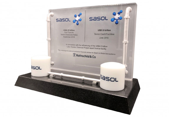 This luxury deal toy, crafted for a multi-billion dollar refinancing deal, combines a color-printed standing crystal plaque with a tapered black base and model pipe details.