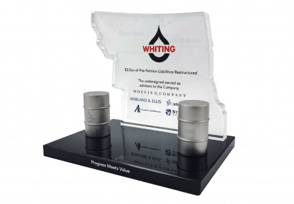 Custom deal toy crafted with a silhouette plaque and model oil barrels presented for a liabilities restructuring.
