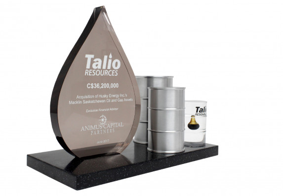 Deal gift with oil drop shaped tombstone plaque and model oil barrels. Presented for an acquisition deal.