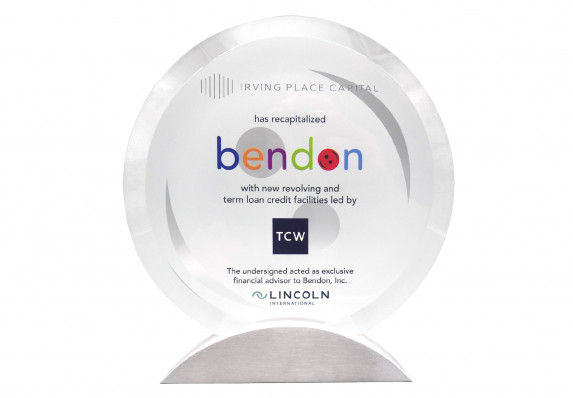 A high-end bevel-edged crystal deal gift with color printed text and logos on machined aluminum base. This tombstone was presented for a recapitalization deal.