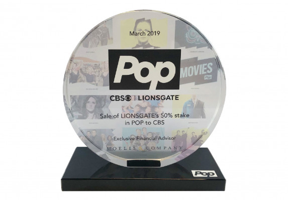 A crystal deal toy with the financial details of a sale of 50% stake in American television station. The piece has reverse color printing and logo detail for an exception luxury effect.