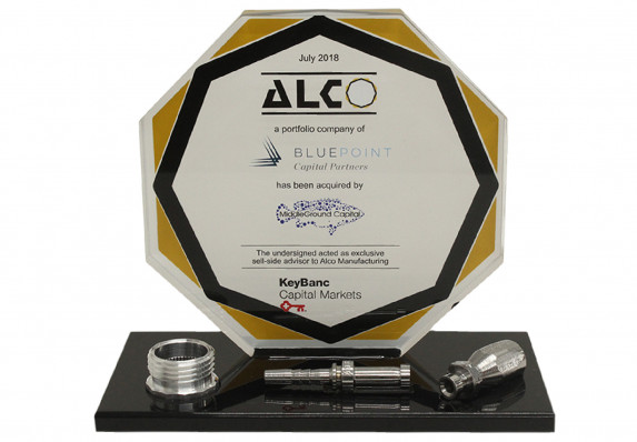 Color printed logo plaque is mounted on a black base with three model components for a sell-side acquisition deal toy.