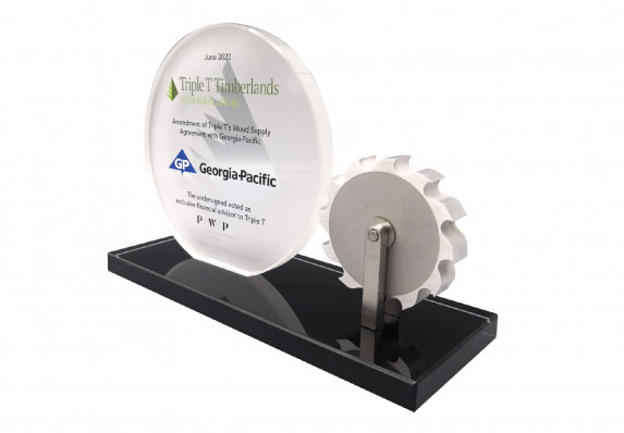 A custom financial tombstone with model saw blade and crystal plaque for a supply agreement deal.