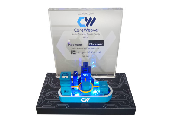 Technology deal toy with an illuminated base and an intricately detailed 3-D print of assets on a crystal base