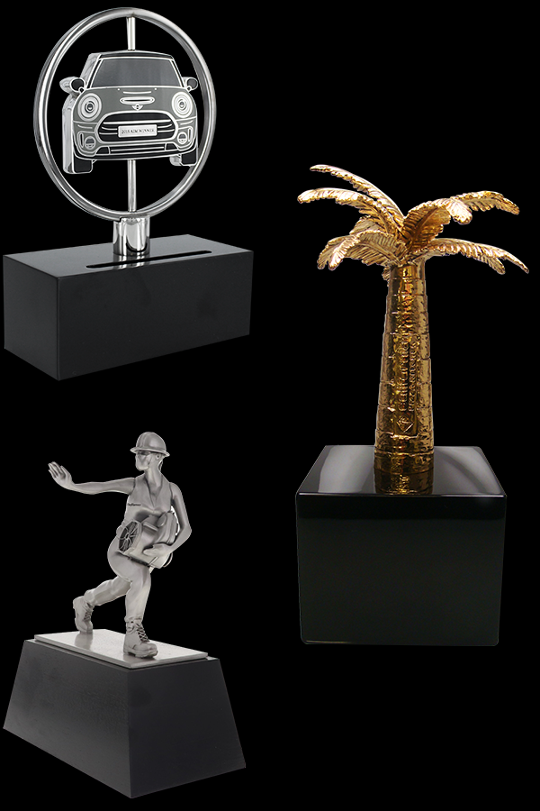 custom awards silver car trophy, gold palm tree award, and miner running trophy